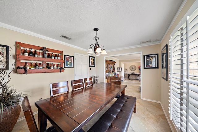 dining space featuring visible vents, light tile patterned flooring, ornamental molding, a textured ceiling, and a chandelier