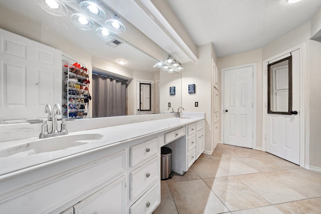 full bathroom with tile patterned floors, visible vents, a sink, double vanity, and baseboards