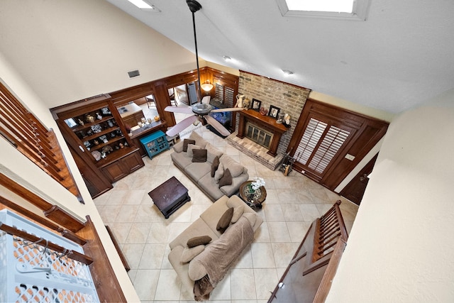 living room with light tile patterned floors, visible vents, a healthy amount of sunlight, and ceiling fan