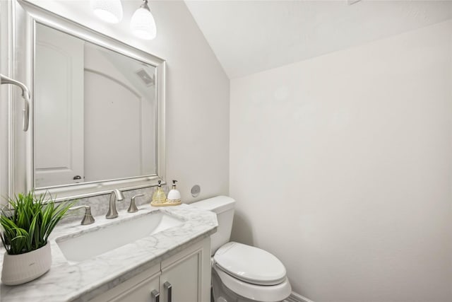 bathroom with vanity, toilet, and visible vents