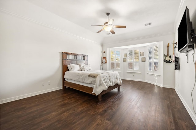 bedroom featuring visible vents, ceiling fan, baseboards, and wood finished floors