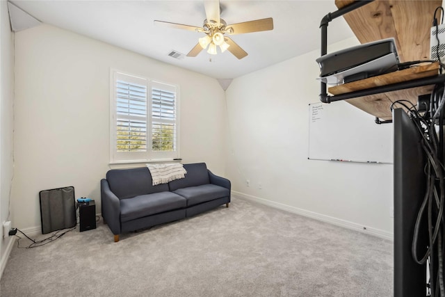 living area with visible vents, a ceiling fan, baseboards, and carpet floors