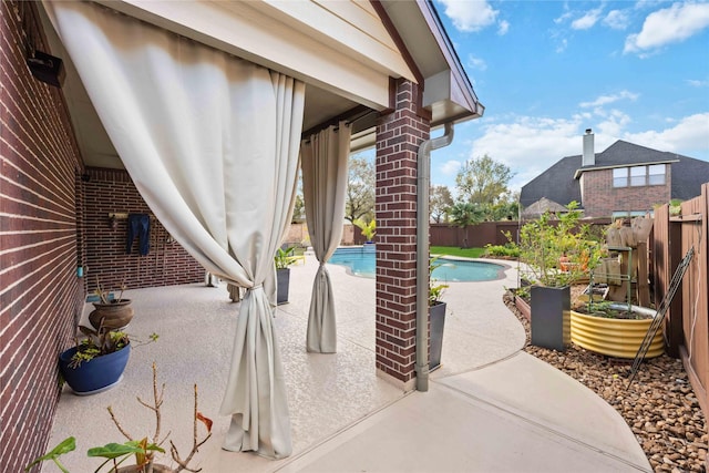 view of patio / terrace featuring a fenced backyard and a fenced in pool