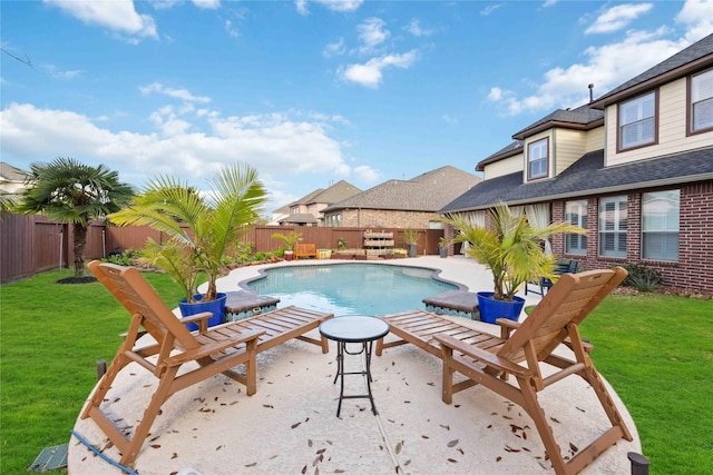 view of pool featuring a yard, a patio, a fenced in pool, and a fenced backyard