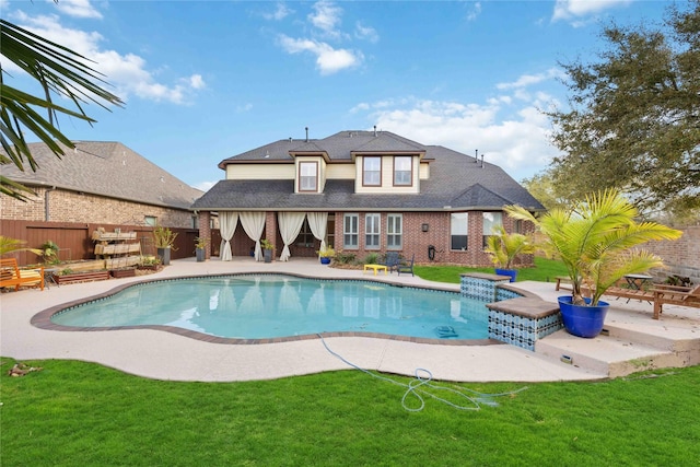 view of swimming pool with a fenced in pool, fence, a patio area, and a lawn