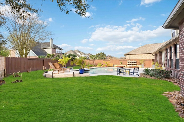 view of yard with a fenced in pool, a fenced backyard, and a patio area