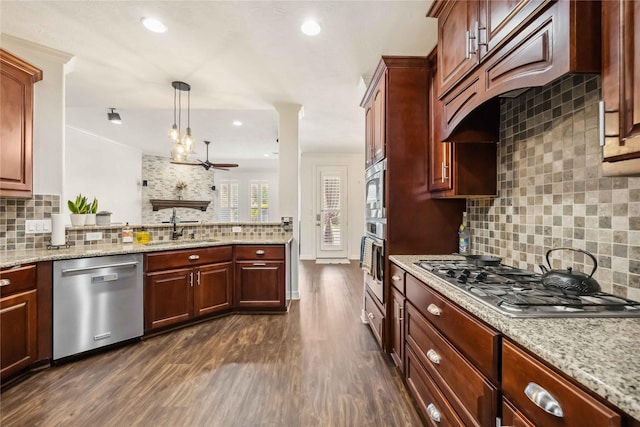 kitchen with a sink, backsplash, custom range hood, appliances with stainless steel finishes, and dark wood-style flooring