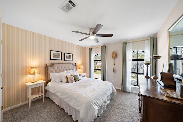 carpeted bedroom with visible vents, wallpapered walls, ceiling fan, baseboards, and access to outside