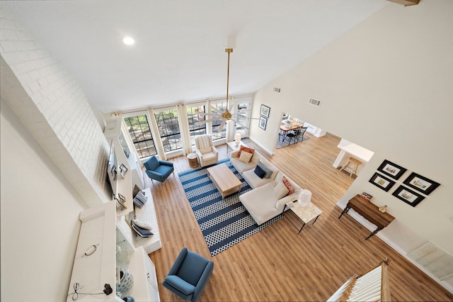 living area featuring visible vents, baseboards, and wood finished floors