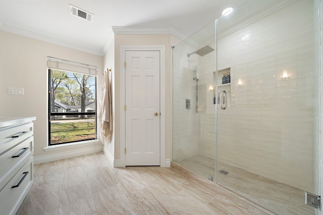 full bath featuring visible vents, a stall shower, crown molding, baseboards, and vanity