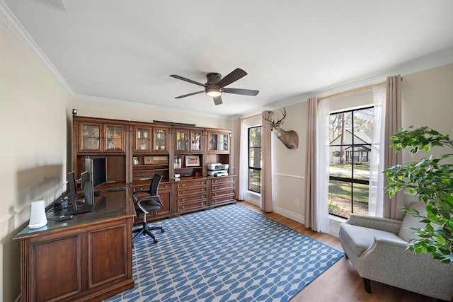 office area featuring baseboards, crown molding, ceiling fan, and wood finished floors