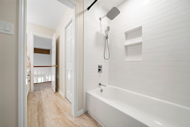 full bathroom featuring baseboards, a textured ceiling, and shower / washtub combination