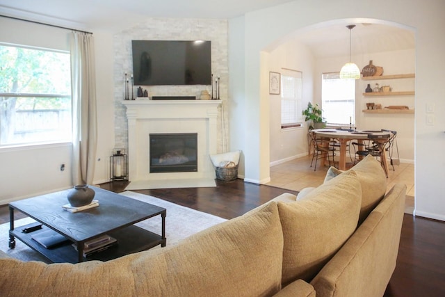 126 Magnolia Grove Ln, Conroe, TX 77384 - living room with baseboards, a large fireplace, a healthy amount of sunlight, and wood finished floors
