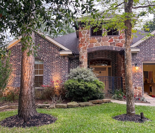 traditional home with brick siding and a shingled roof