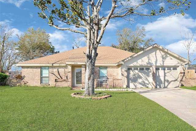 ranch-style house featuring a front yard, an attached garage, brick siding, and driveway