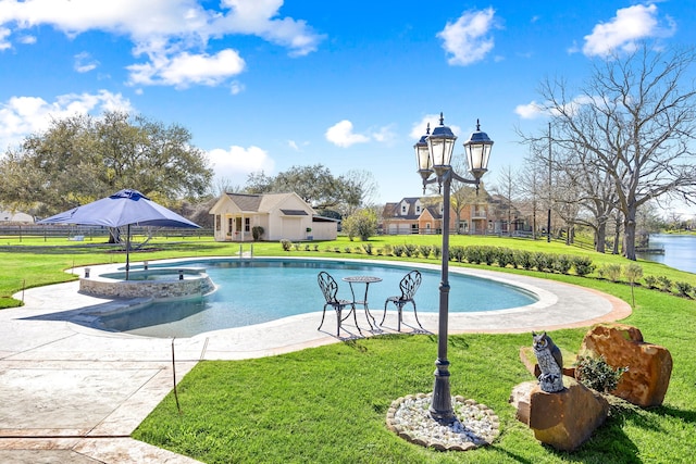 view of pool featuring an outbuilding, a lawn, fence, and a pool with connected hot tub