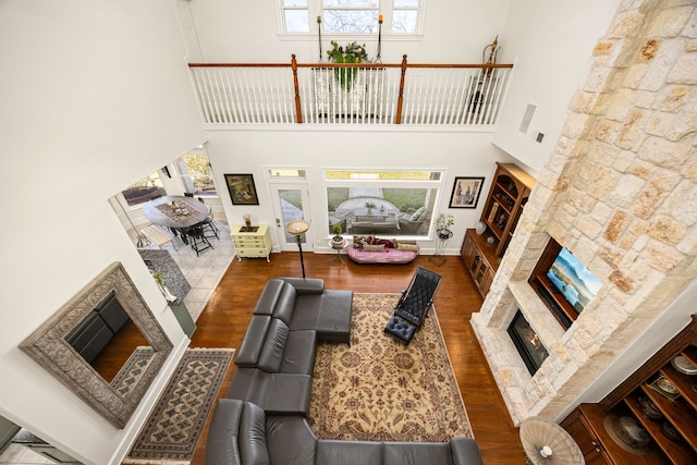 living room featuring a wealth of natural light, a fireplace, and wood finished floors