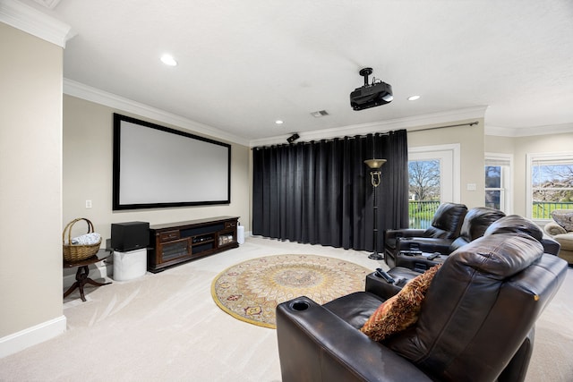 home theater with crown molding, carpet, visible vents, and baseboards