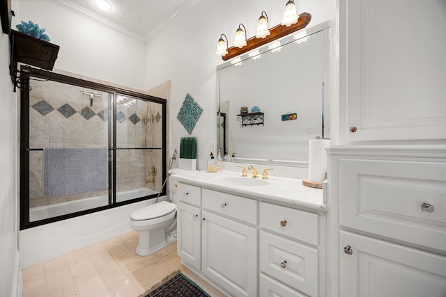 full bathroom featuring combined bath / shower with glass door, toilet, vanity, and crown molding