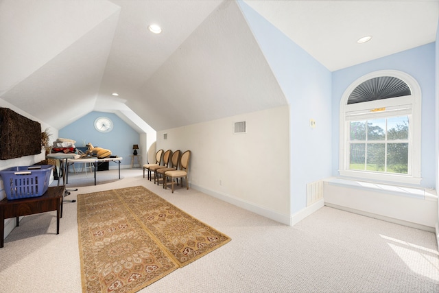 interior space featuring visible vents, baseboards, carpet flooring, and vaulted ceiling