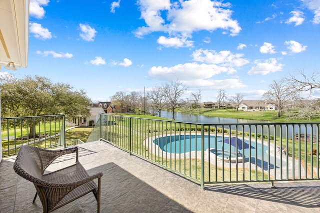 view of patio / terrace featuring a residential view, a water view, and a balcony