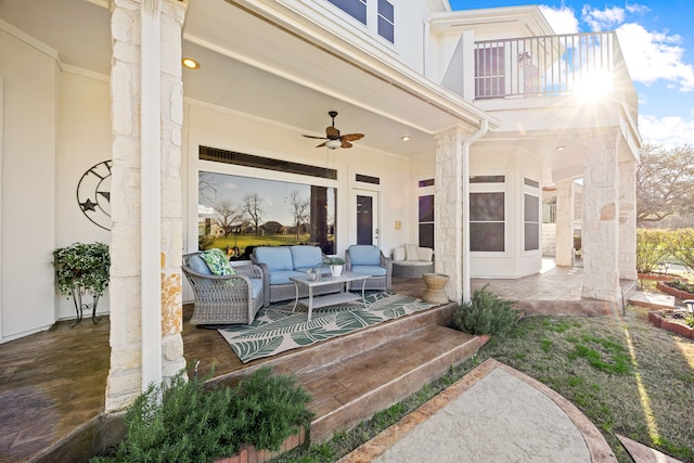 view of patio featuring a balcony, a ceiling fan, and an outdoor hangout area