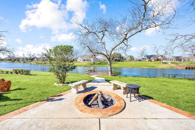 view of patio with a water view and an outdoor fire pit