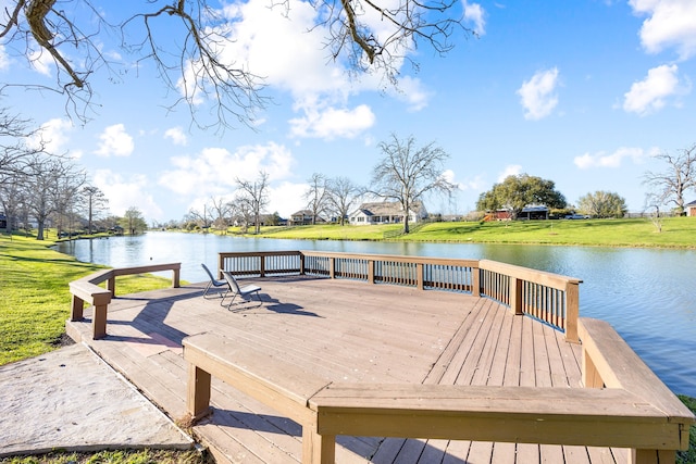 dock area featuring a lawn and a deck with water view