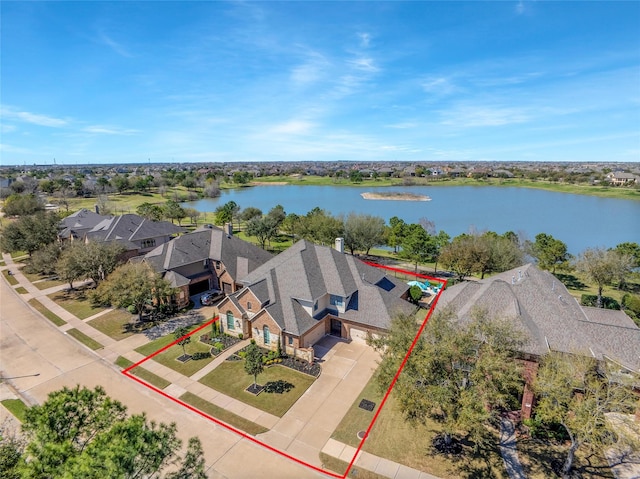 drone / aerial view featuring a residential view and a water view