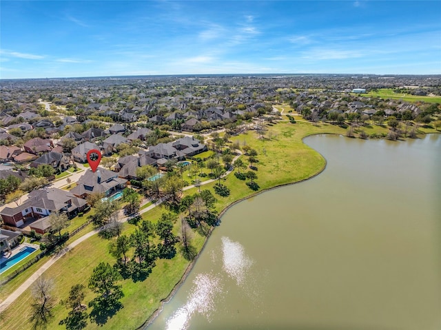 drone / aerial view featuring a residential view and a water view