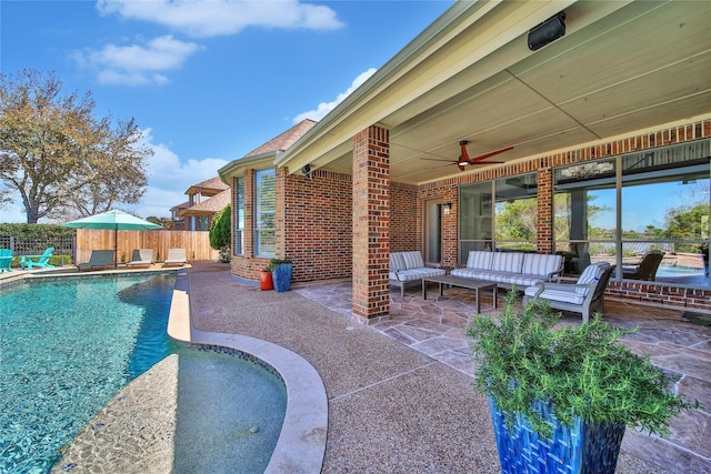 view of swimming pool featuring fence, a ceiling fan, and a patio area