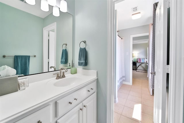 bathroom featuring visible vents, baseboards, vanity, and tile patterned flooring