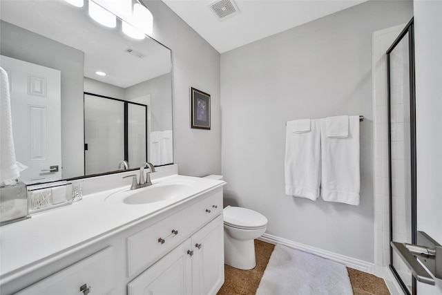 bathroom with visible vents, baseboards, toilet, a tile shower, and vanity