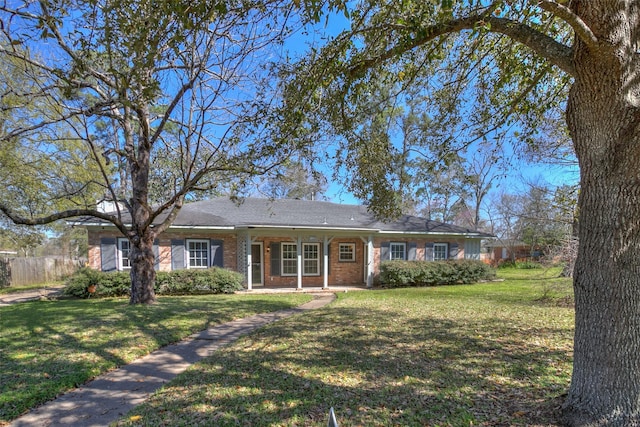 ranch-style home with brick siding and a front lawn