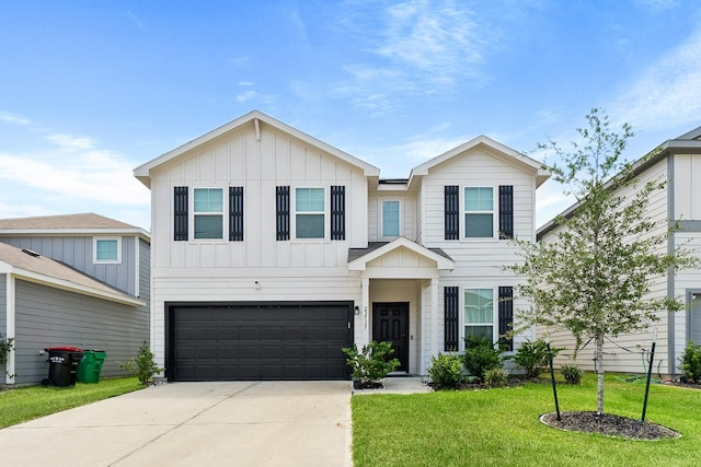 view of front facade with a front lawn, an attached garage, board and batten siding, and driveway