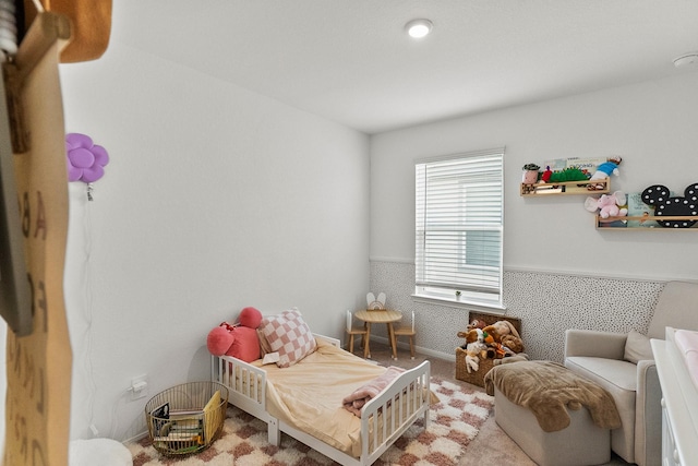 bedroom with carpet and wainscoting