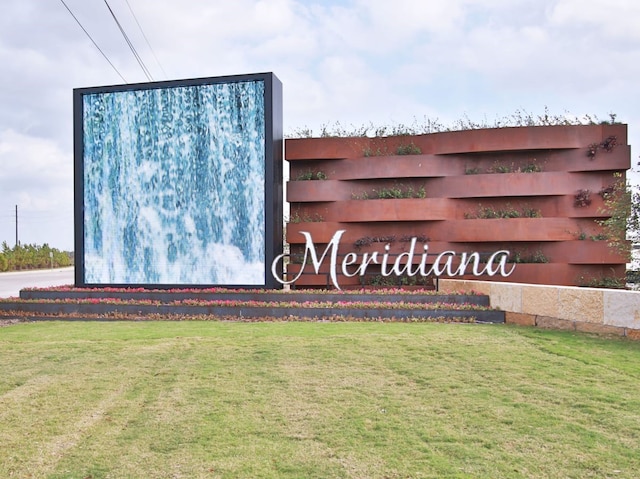 community / neighborhood sign featuring a lawn