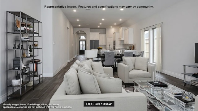 living room featuring recessed lighting, dark wood-style floors, arched walkways, and baseboards