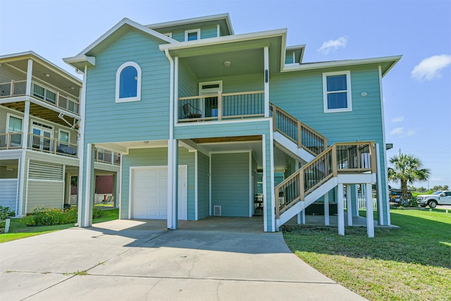 view of front of house featuring stairway, a carport, concrete driveway, and a front lawn