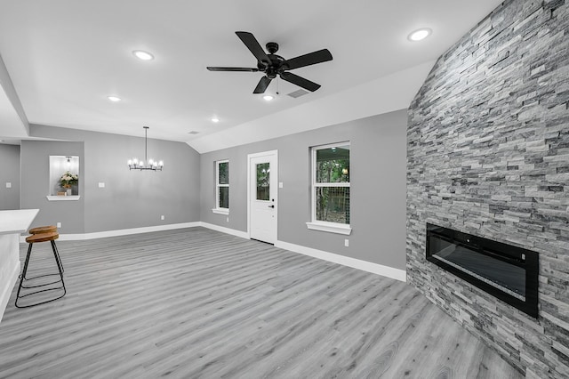 17127 Port O Call St, Crosby, TX 77532 - unfurnished living room with wood finished floors, baseboards, lofted ceiling, a fireplace, and ceiling fan with notable chandelier