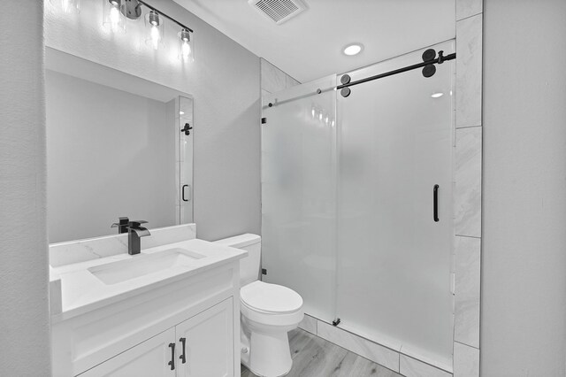 17127 Port O Call St, Crosby, TX 77532 - bathroom with visible vents, toilet, wood finished floors, a shower stall, and vanity