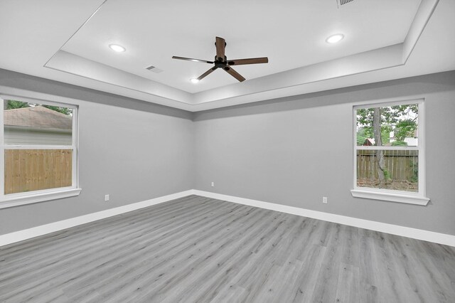 17127 Port O Call St, Crosby, TX 77532 - empty room featuring a ceiling fan, a raised ceiling, baseboards, and wood finished floors