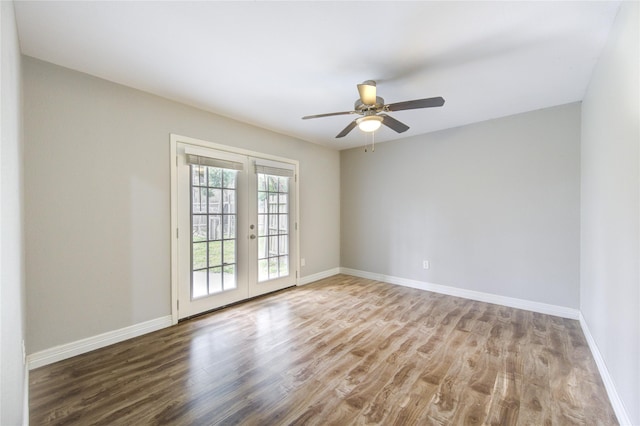 empty room with ceiling fan, french doors, baseboards, and wood finished floors