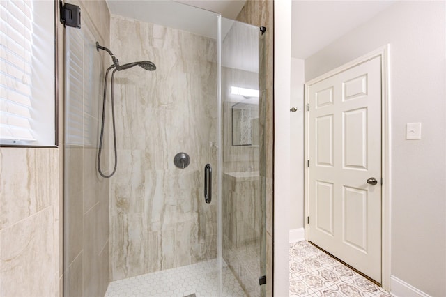 full bath featuring baseboards and a stall shower