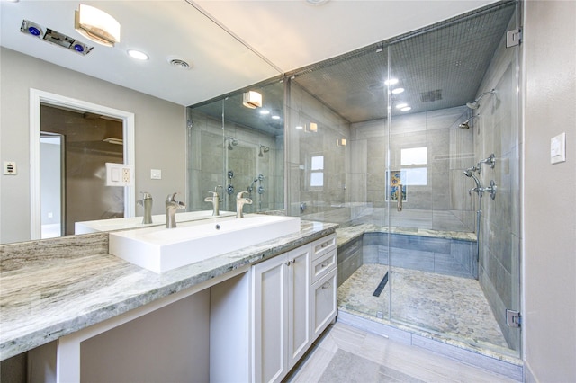 bathroom with visible vents, recessed lighting, a stall shower, and vanity