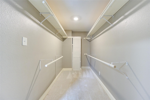 walk in closet with carpet