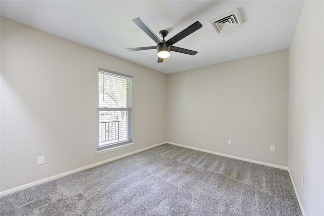 unfurnished room with carpet flooring, a ceiling fan, visible vents, and baseboards