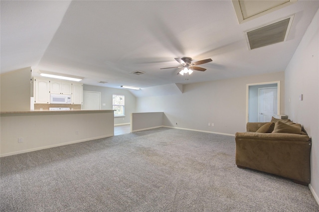 unfurnished living room featuring visible vents, a ceiling fan, carpet flooring, baseboards, and vaulted ceiling