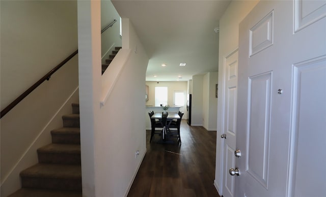 entryway featuring stairway, dark wood-style floors, and baseboards