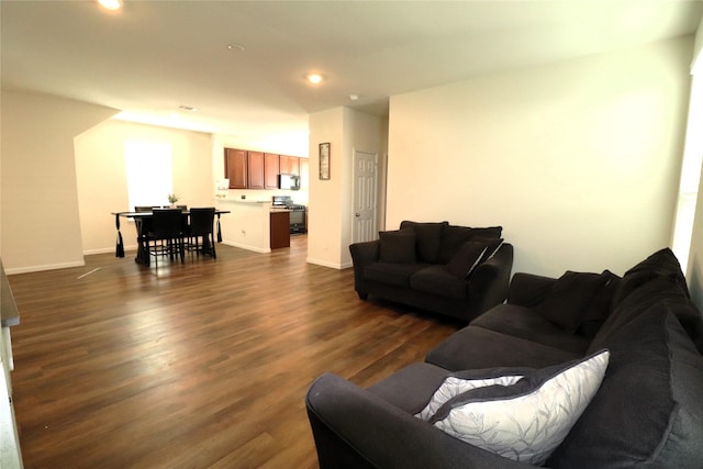 living area with recessed lighting, baseboards, and dark wood-style flooring